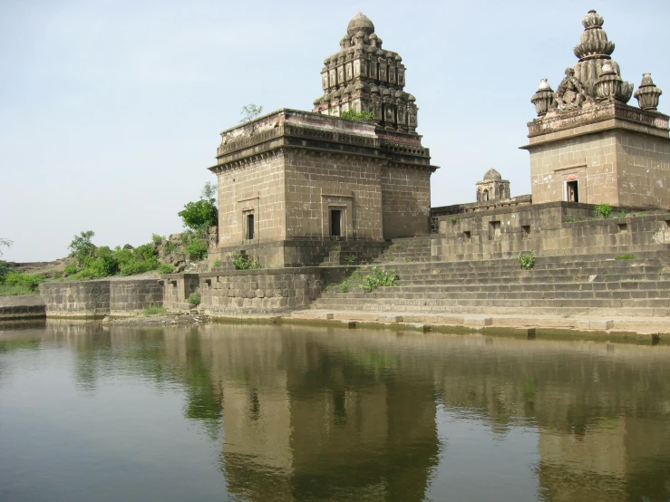 a castle by the water with lots of walls and towers