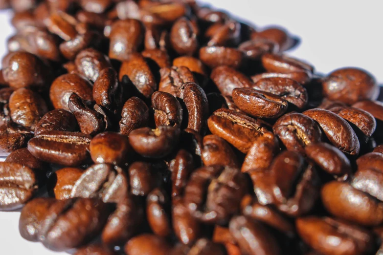 a large pile of brown roasted coffee beans