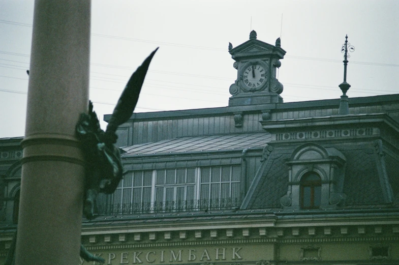 an old building has a clock tower and metal balconies