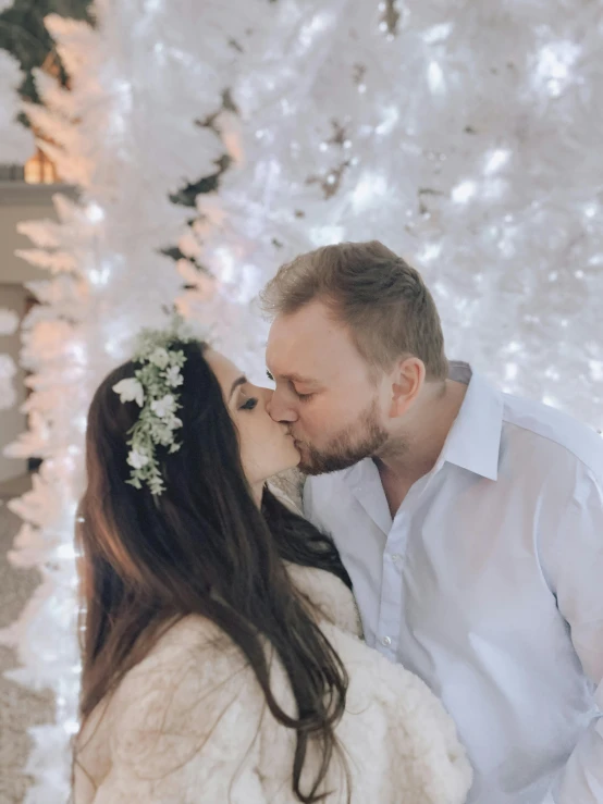 this beautiful young couple is cuddling under a tree