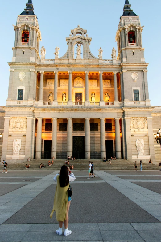 a group of people standing in front of a large building