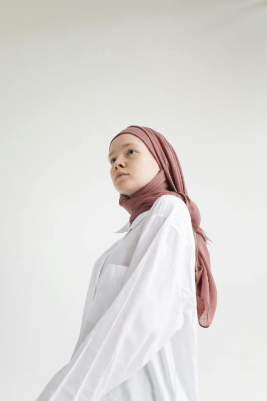 a young woman stands in an empty room