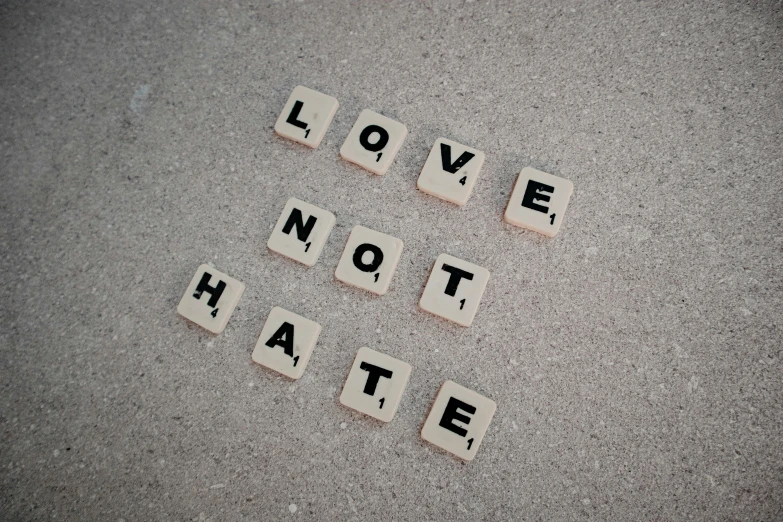 i love not hate scrabbled into cement type blocks