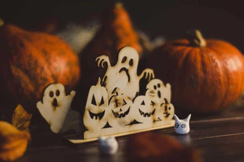 wooden carved halloween scenes displayed on counter