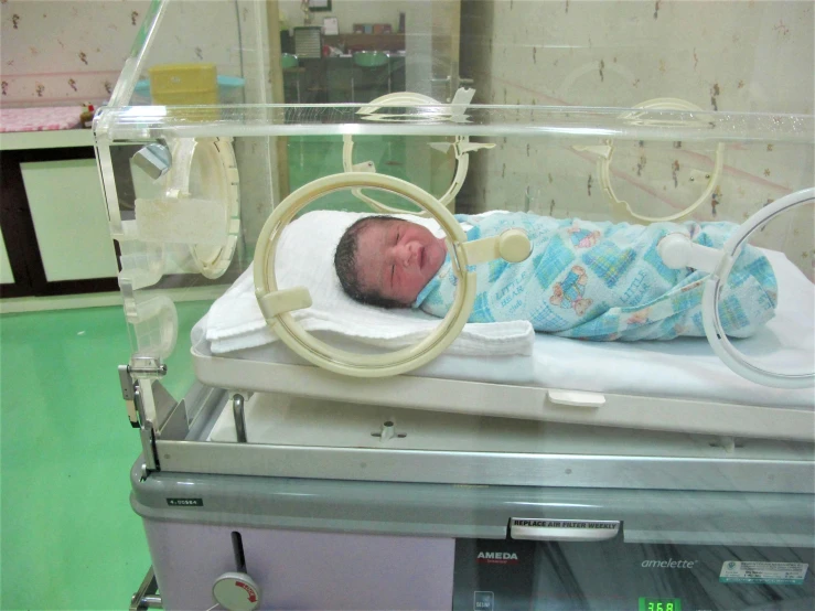 a baby is in an iv stand with wheels