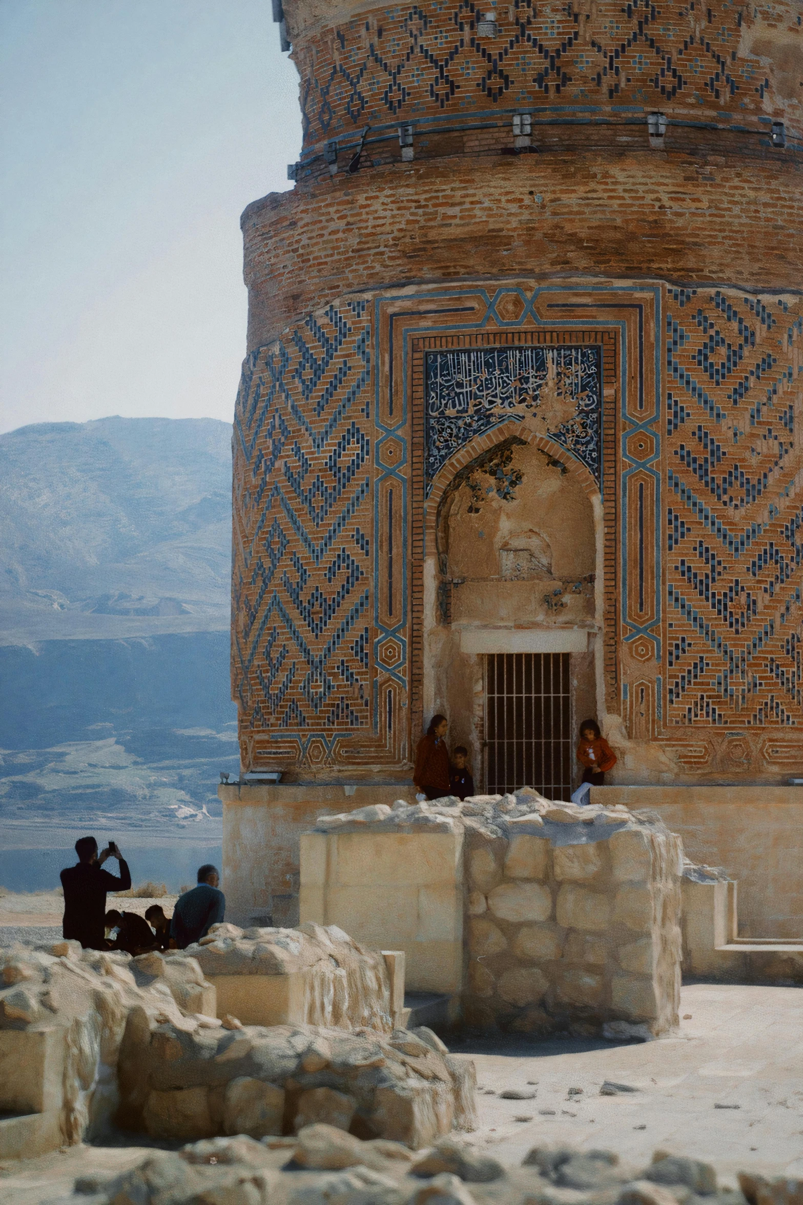 three people are sitting outside an elaborate building