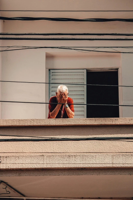 a woman standing at the top of a balcony taking a picture