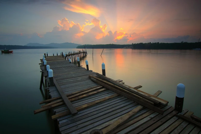 dock with a row of chairs on water