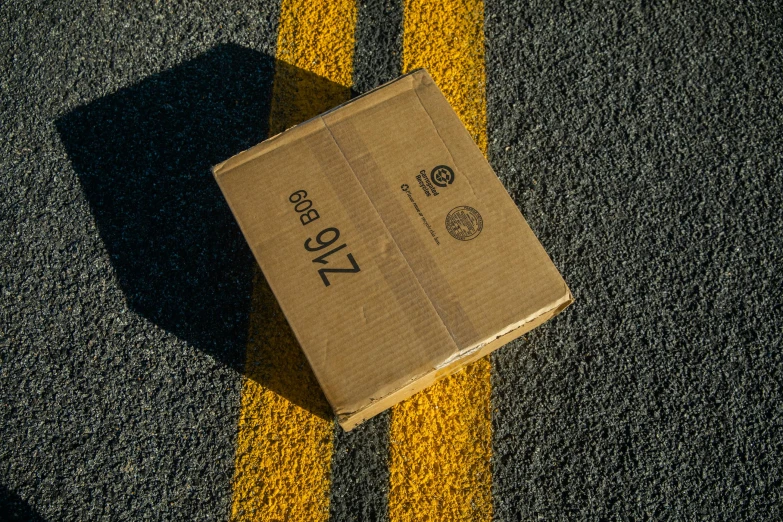 a brown box sitting on top of a road