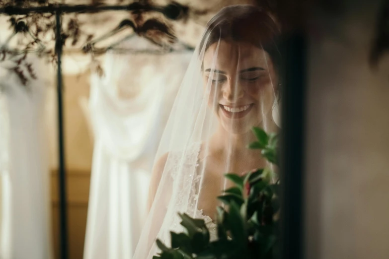 a bride smiles while getting ready for her wedding