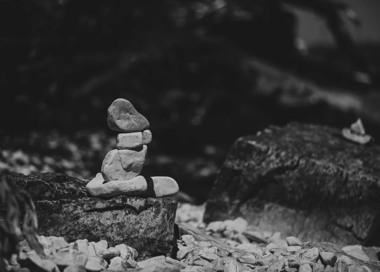 small stones piled into the shape of a human face on top of rocks