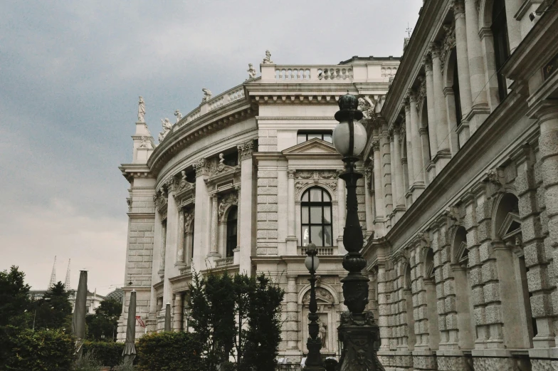 the large stone building has a clock on it's side