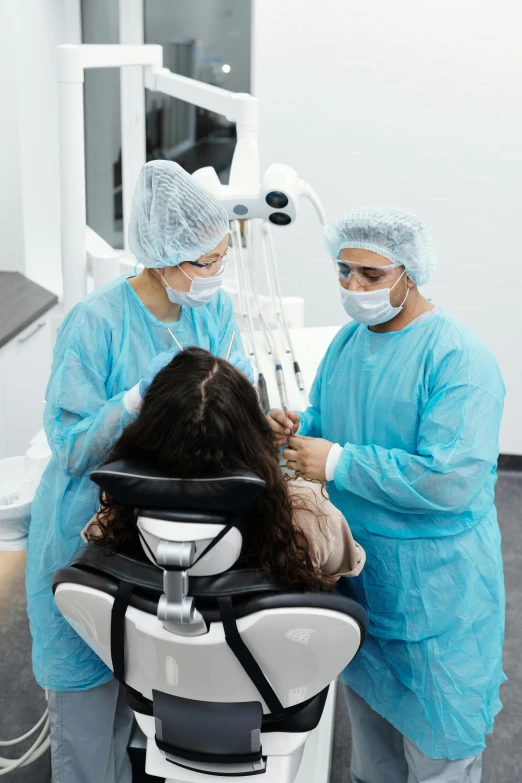 a man and woman getting dental care from a dentist