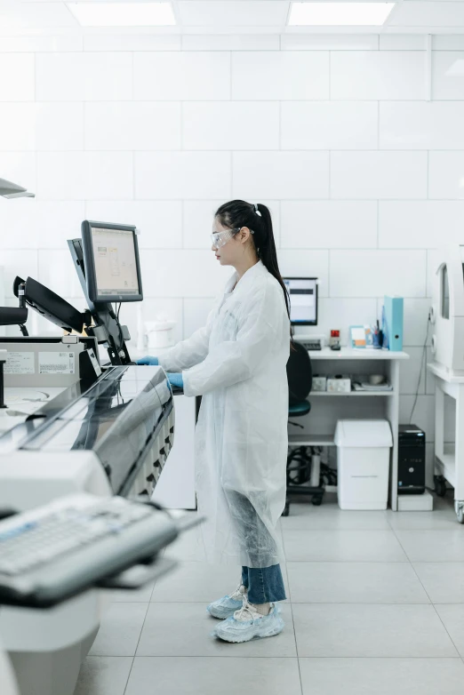 a female wearing lab coats in a room
