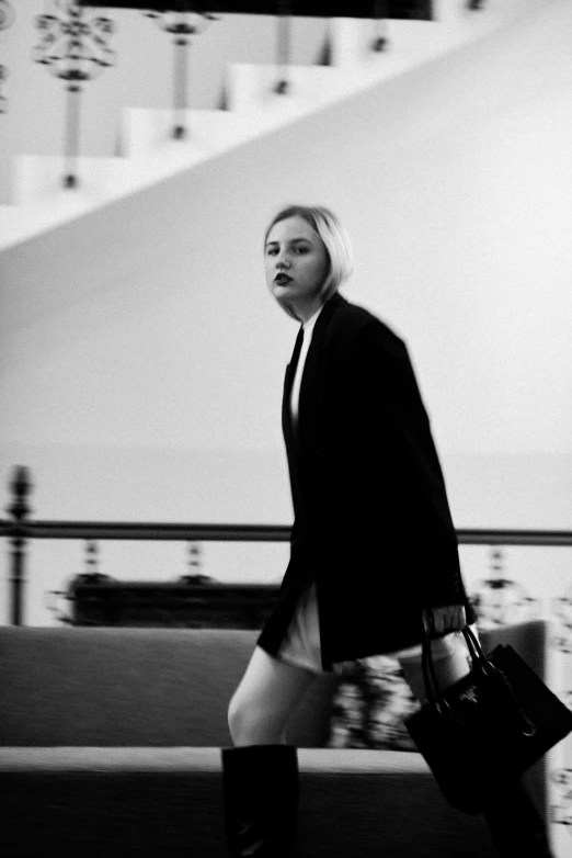 a woman with a purse walking down the street