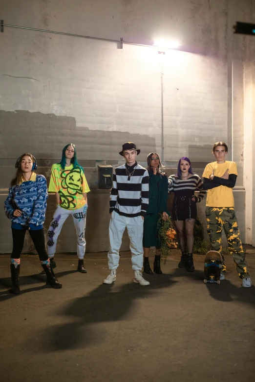 several young people are standing in the parking garage with their skateboards