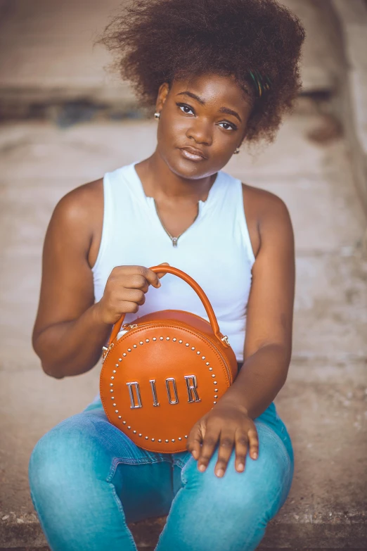 this black woman is holding a bag in one hand and a purse in the other