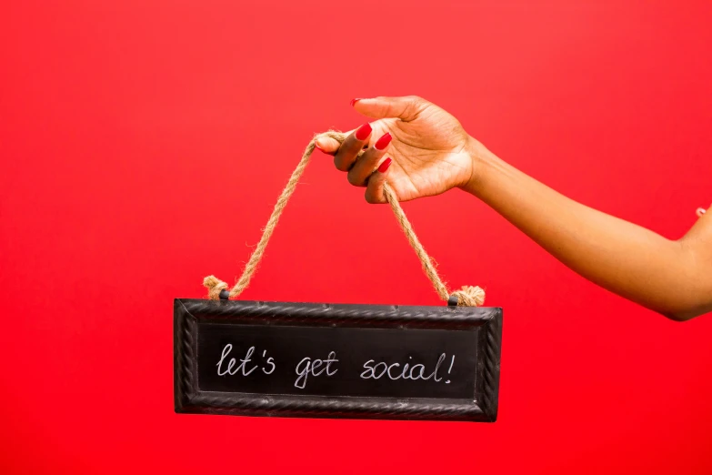 a woman holds a sign that reads, let's get social