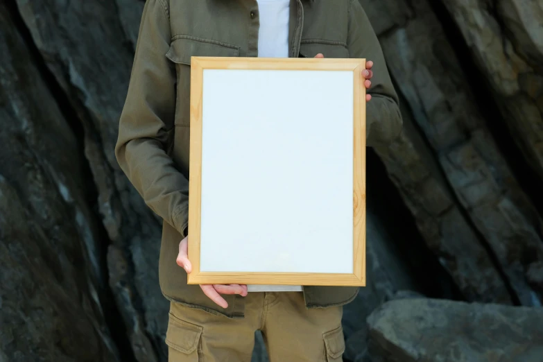 a man holding a small white board in his hands