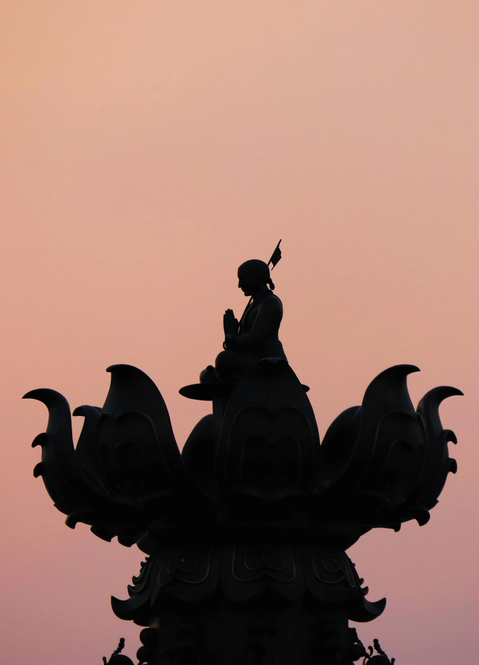 a weather vane on top of a tower at dusk