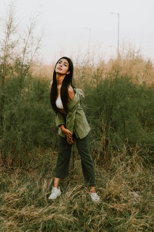 a woman in the middle of an open field