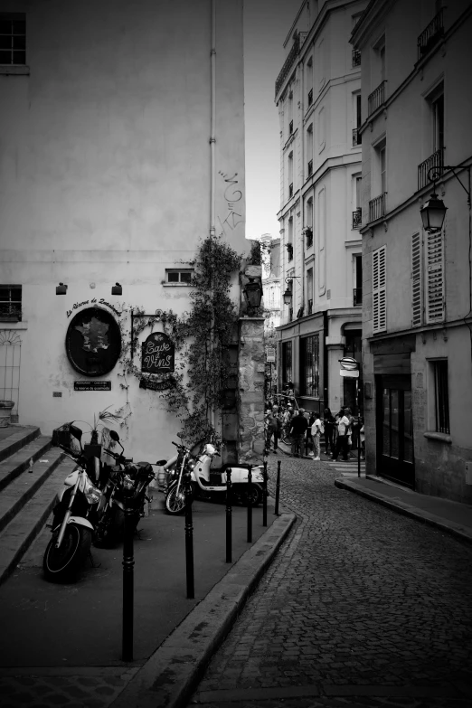 a street with some motor bikes parked near a building