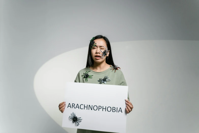 a person holding up a sign with the words aranchhophobia written on it