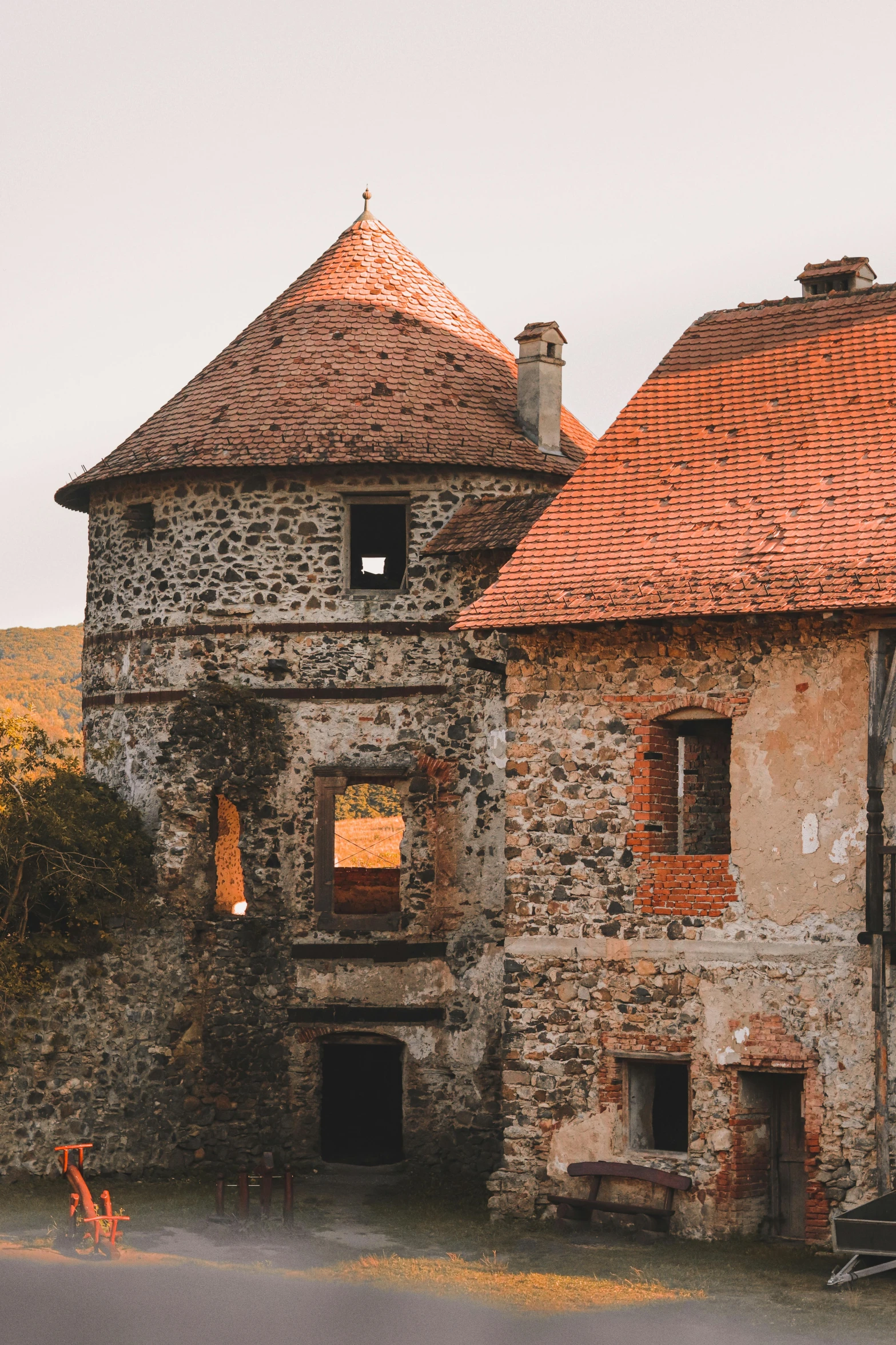 an old house with a very large round red roof