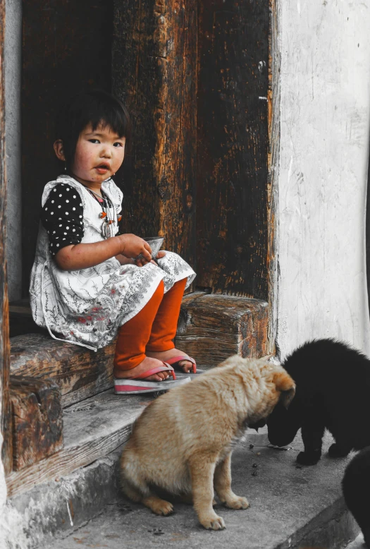 two small children sitting on the porch with their mother's pet