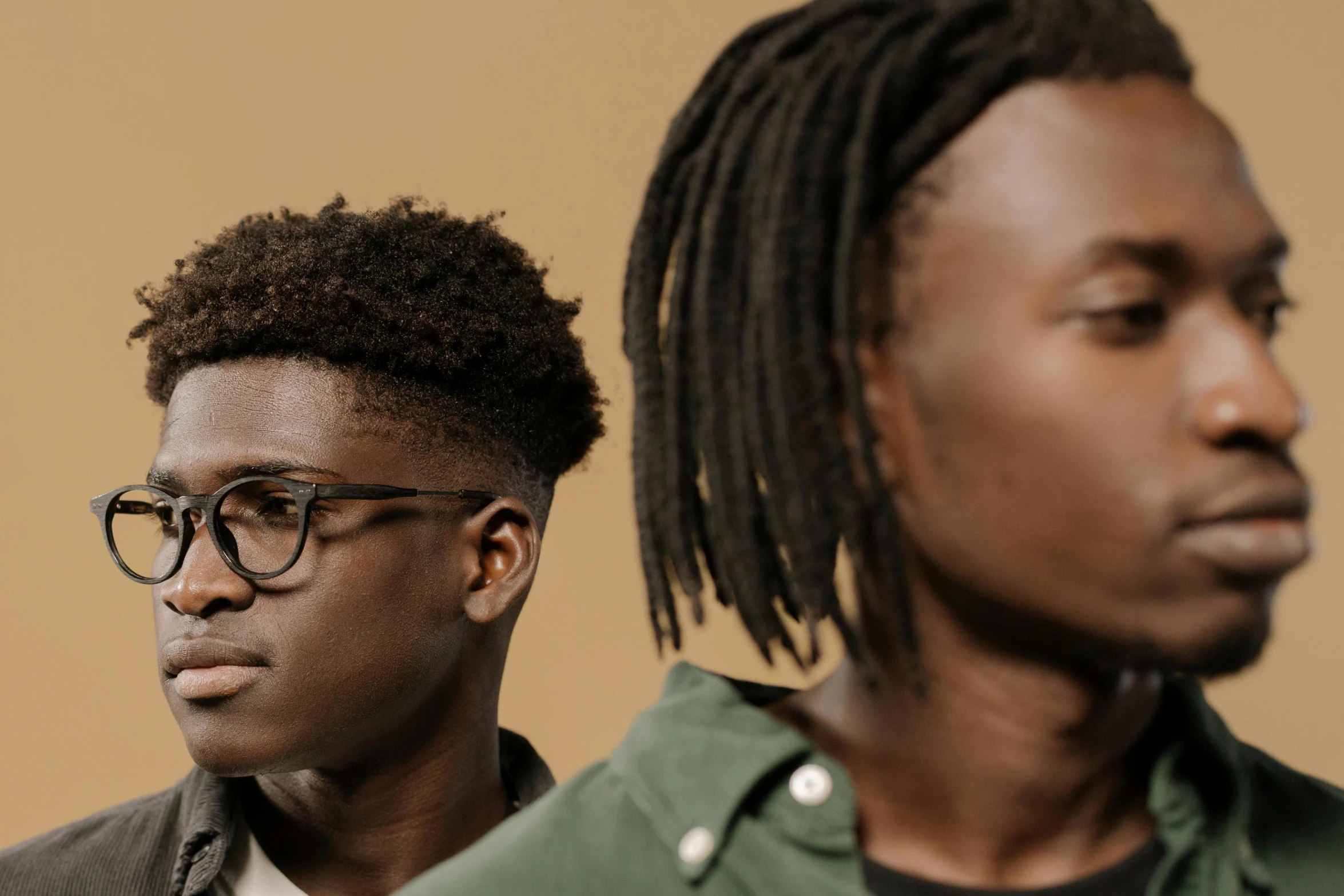 two men, one with glasses and the other with dreadlocks