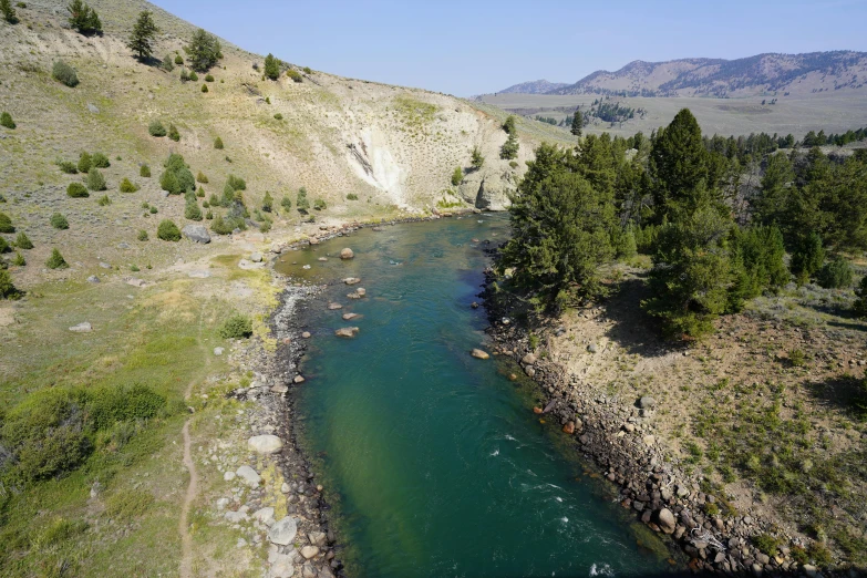 a river with a steep cliff in the background