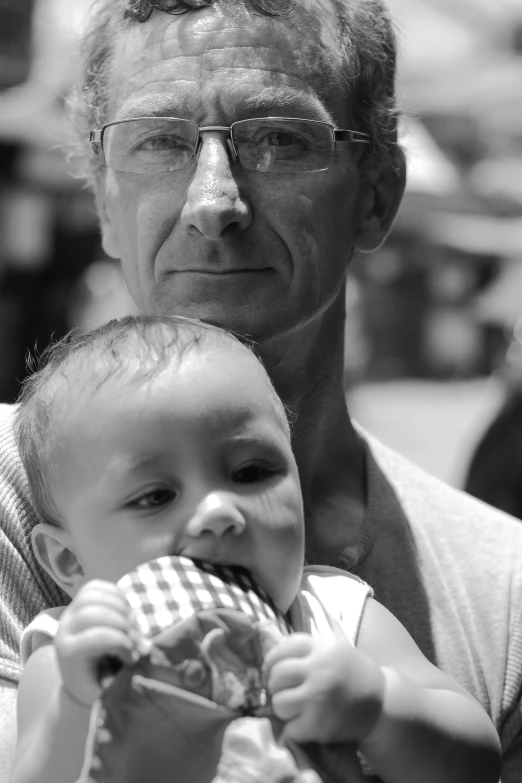 black and white pograph of a man holding a small child
