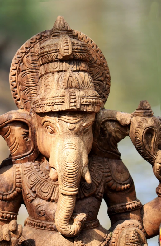 an elephant and his family carved of wood