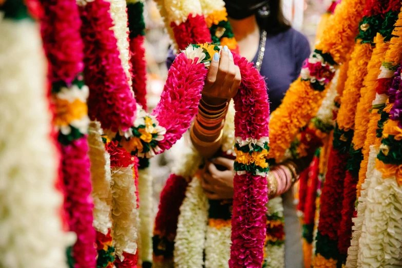 the woman is standing in line with her hands around flowers