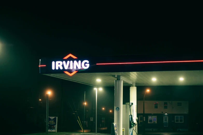 the lights shine brightly on the building and the gas station