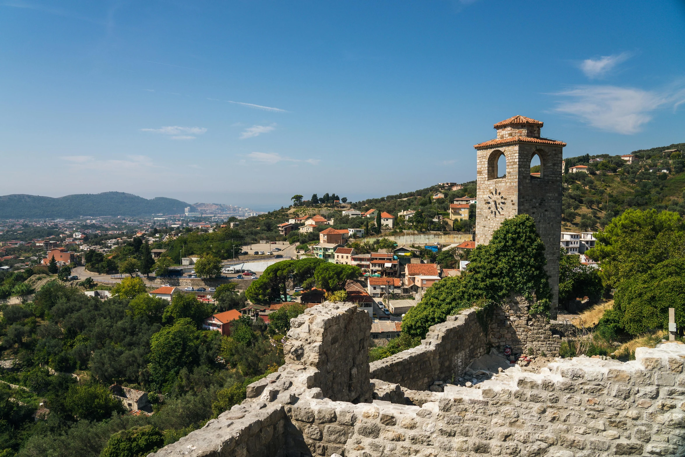 a clock tower on the side of a mountain