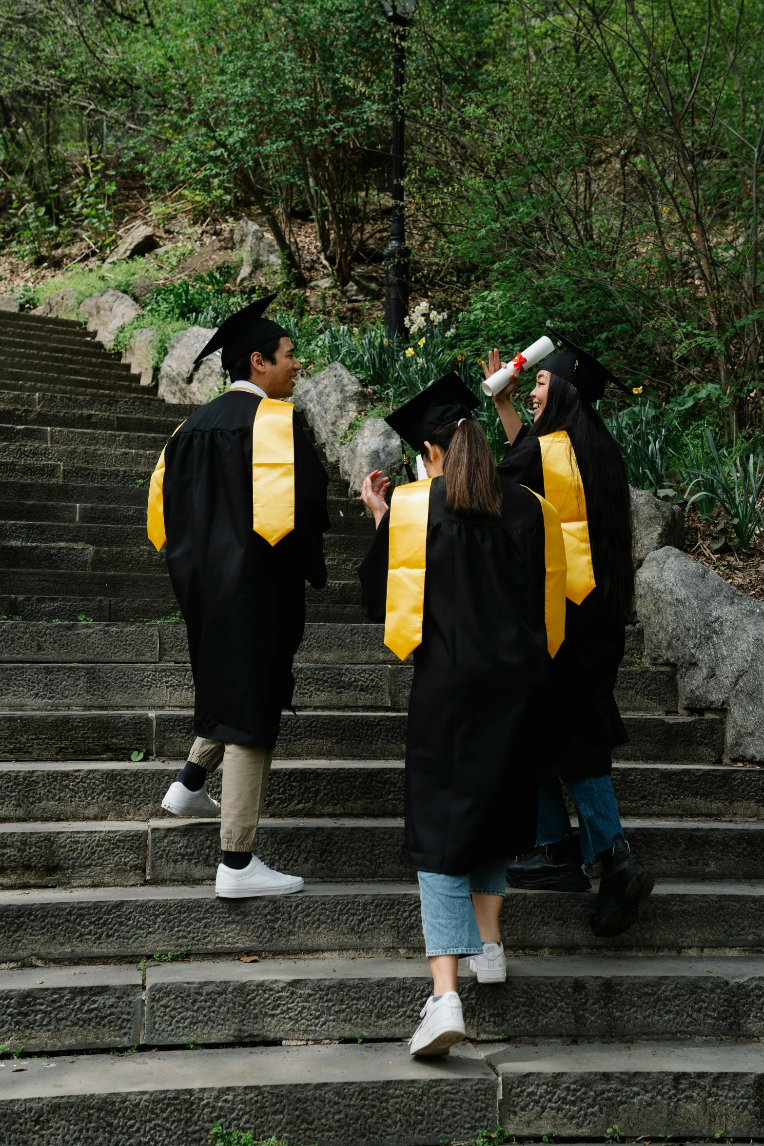 a group of people dressed in cap and gowns walking down stairs