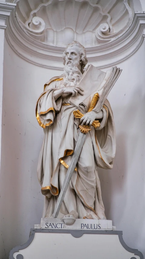 an old statue of a man holding a sword
