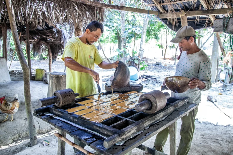 two men working in an outdoor area with metal objects