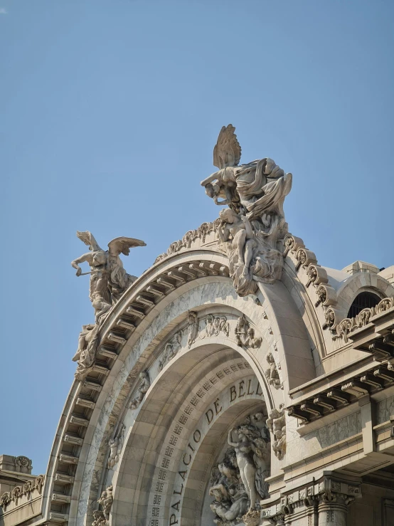 a very ornate building with statues on top