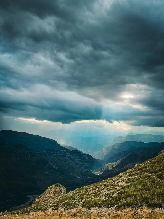 rain clouds roll in over the mountains and valley