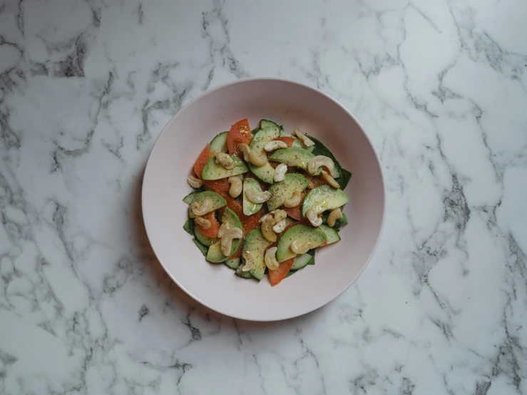 a white plate holding mixed vegetables with orange