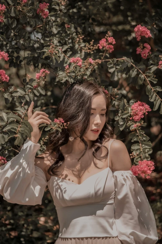 a woman in a white dress posing for a po