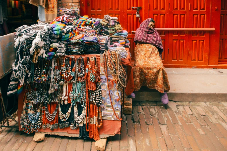 an outdoor shop with beads and hats outside