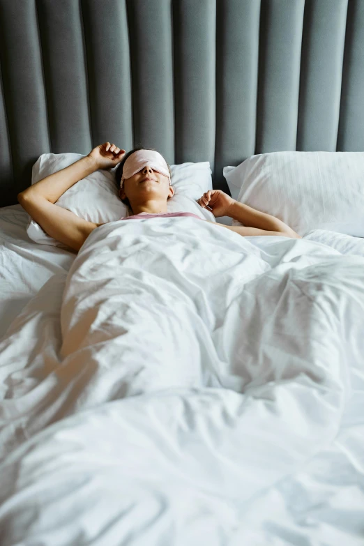 a man laying in bed with his eyes closed