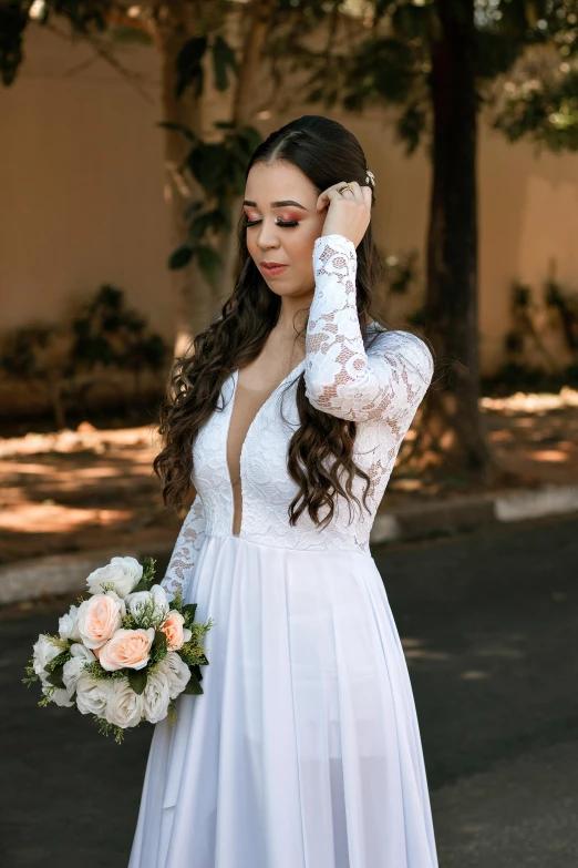 the woman is posing in her wedding dress