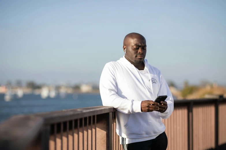 a person on a bridge holding a cell phone