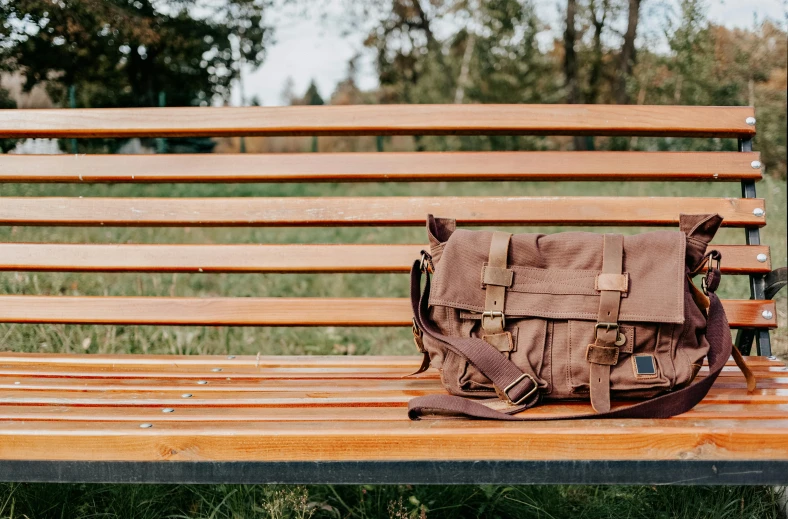 a purse laying on a wooden bench