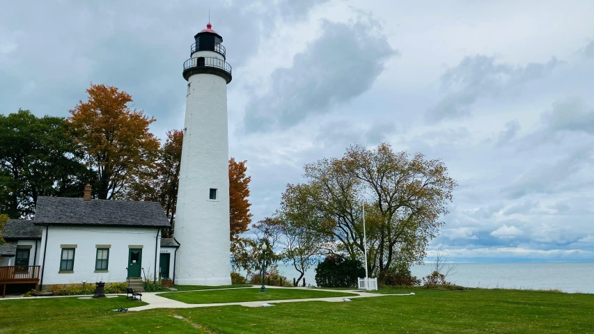 the lighthouse sits in front of some water