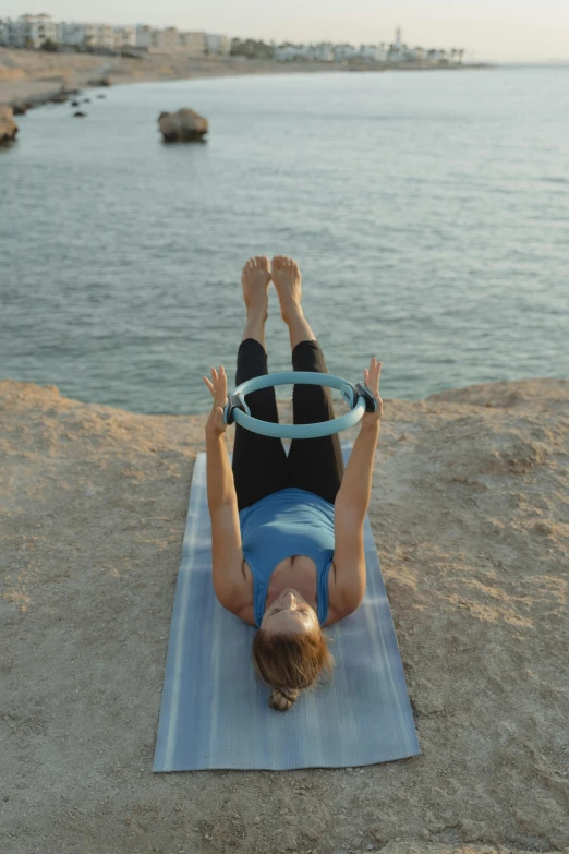 a woman is doing a hammock on the beach